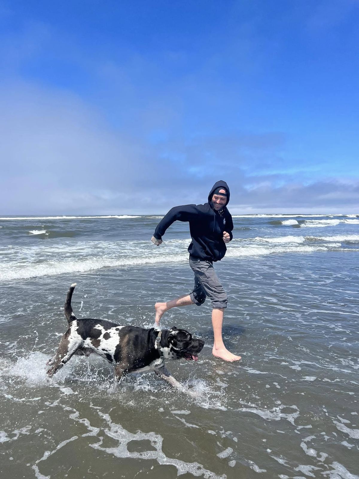 Scoop running barefoot through the surf with Dude